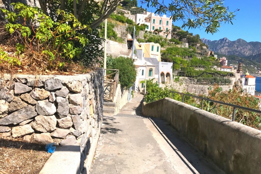 The cliff walkway is a well-paved stone track.