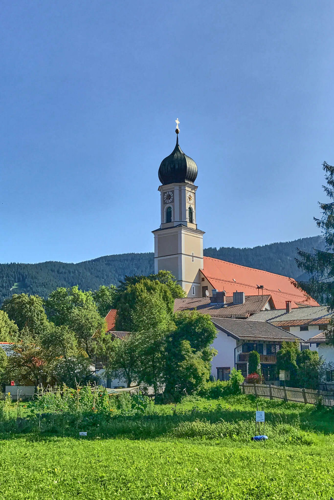 View of Parish Church St. Peter and Paul from the parking lot outside of the small town Oberammergau, southern Germany