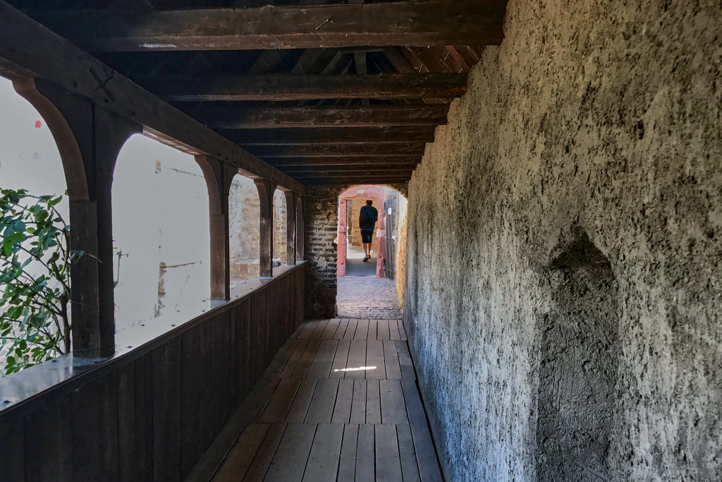 The well-preserved wooden covered bridge leads to the castle square
