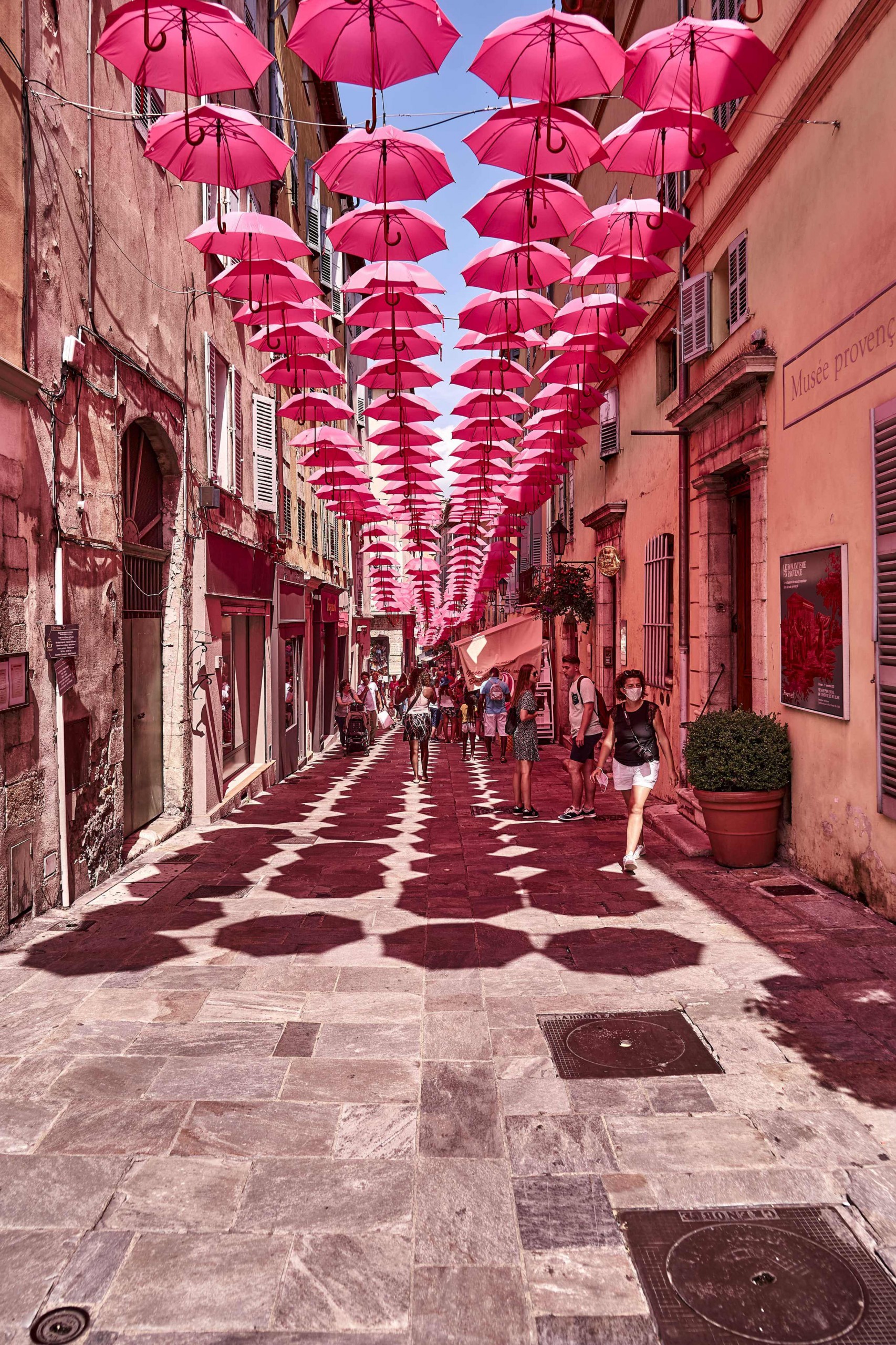an art installation of pink umbrellas
