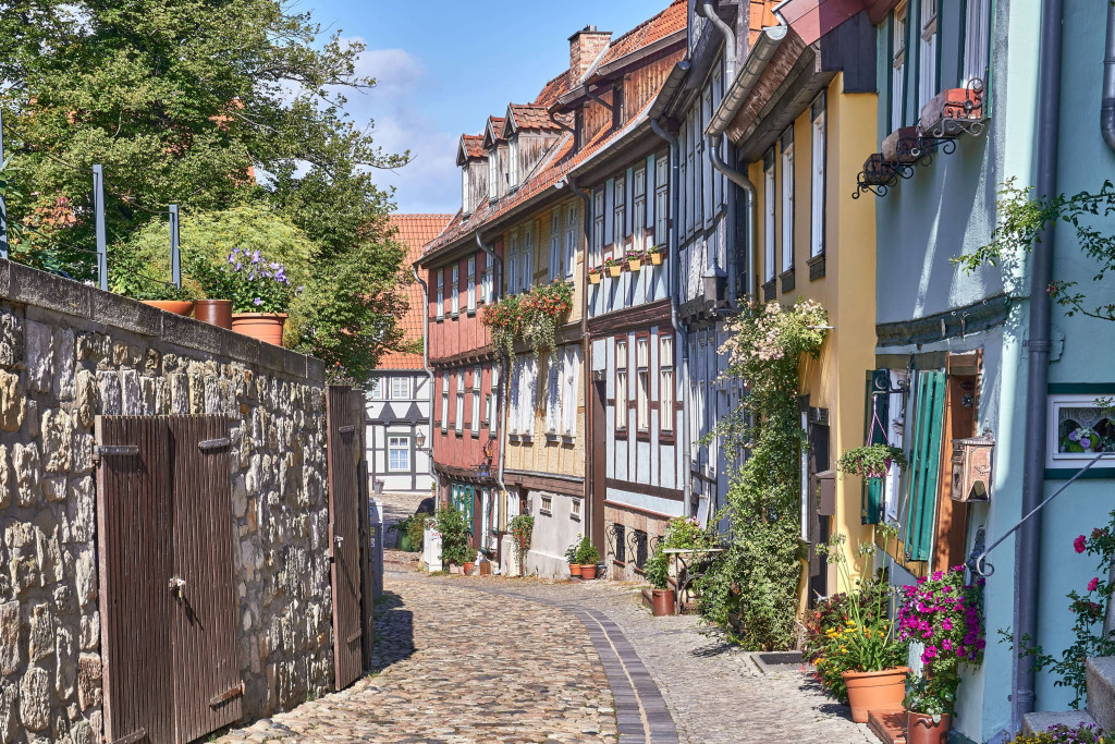 The small street parallel to the hill consists of many half-timbered houses, colourful painted and beautifully decorated; The Old Town of Quedlinburg