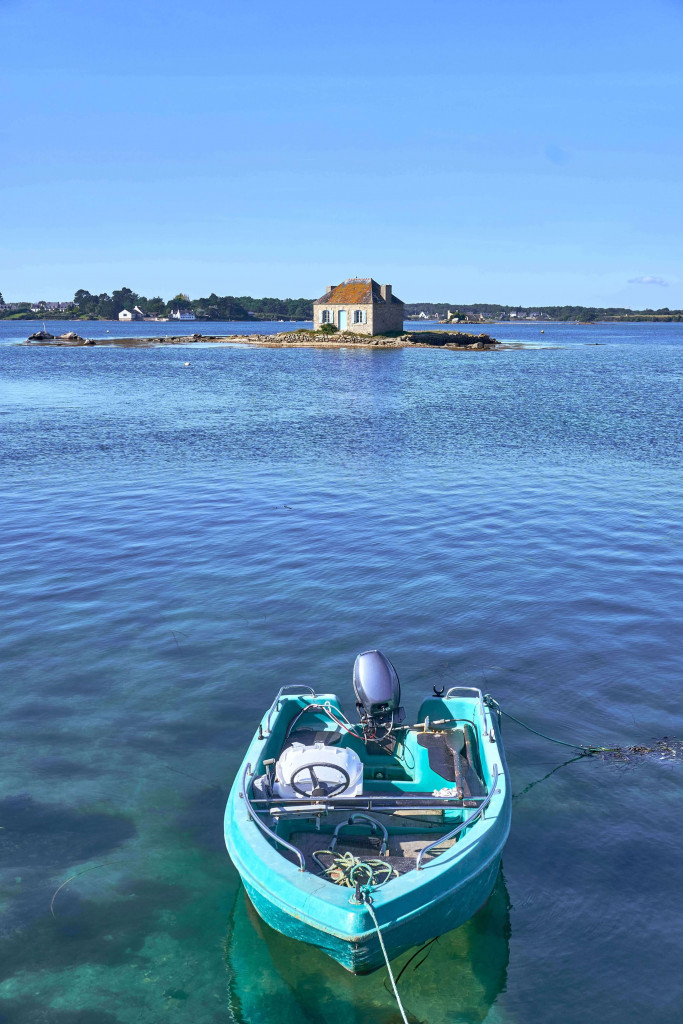 View of Little cottage with blue shutters (Nichtarguer) from the stone bridge, Saint-Cado;